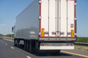 rear view of white semi truck on freeway