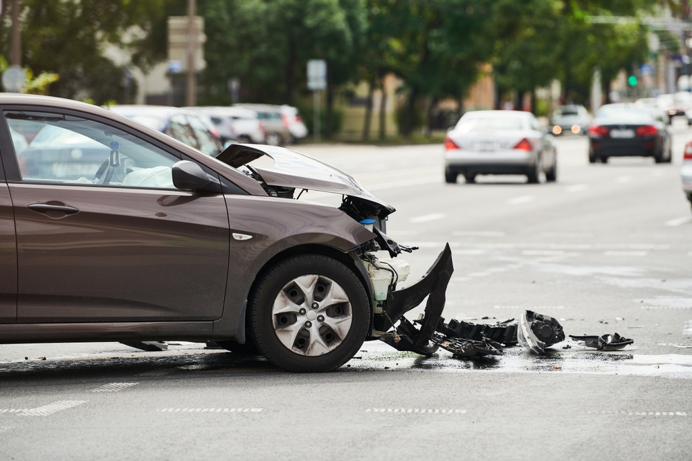 wrecked car left in intersection after other driver leaves scene of accident